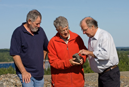 Adex's resident geologist Gustaaf Kooiman (centre) views molybdenum ore with mine site manager Roger Young (left) and company's VP of Operations Victor Hendricken (right), Mount Pleasant mine.
